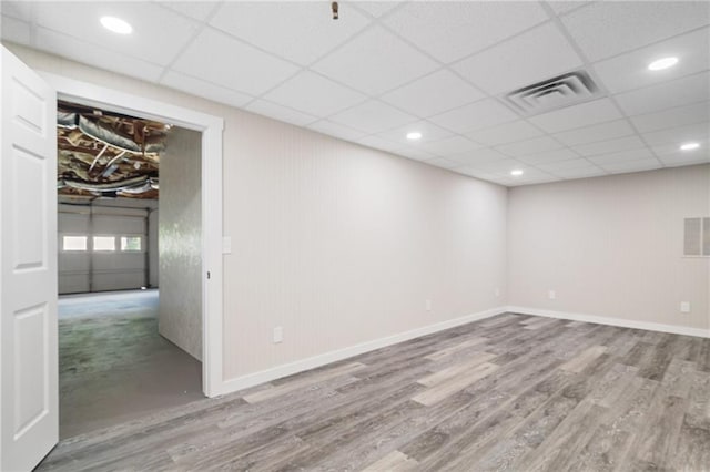 201 Rustin Dr, Dallas, GA 30157 - below grade area with a paneled ceiling, baseboards, visible vents, and wood finished floors