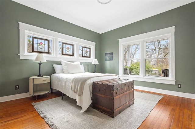 bedroom with hardwood / wood-style floors and baseboards