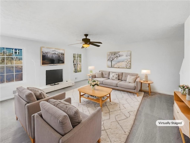 living room with a wealth of natural light, baseboards, and ceiling fan