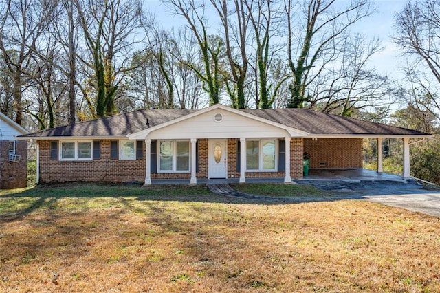 single story home featuring covered porch, a front yard, and a carport