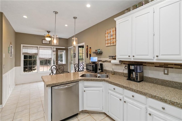 kitchen featuring kitchen peninsula, white cabinetry, ceiling fan, and stainless steel dishwasher