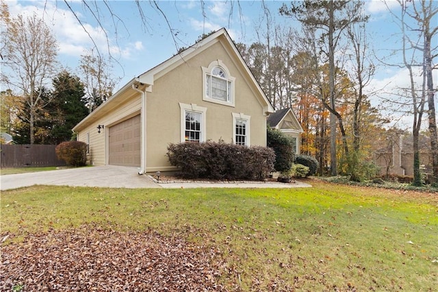 view of side of home with a lawn and a garage