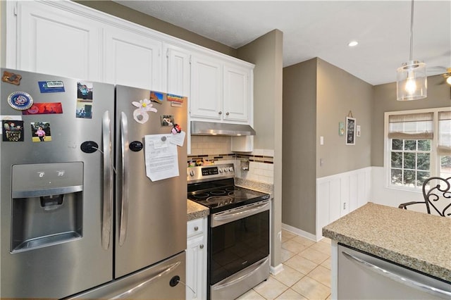 kitchen featuring light tile patterned floors, tasteful backsplash, pendant lighting, white cabinets, and appliances with stainless steel finishes