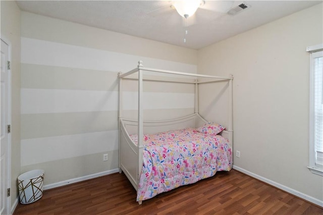 bedroom with dark hardwood / wood-style floors and ceiling fan