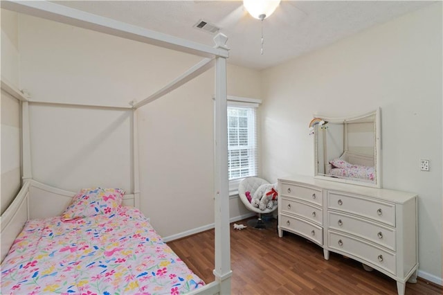 bedroom featuring ceiling fan and dark hardwood / wood-style flooring