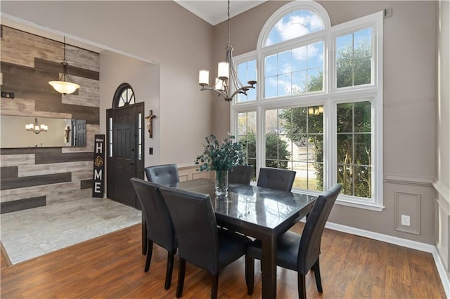 dining area featuring dark hardwood / wood-style floors and a notable chandelier