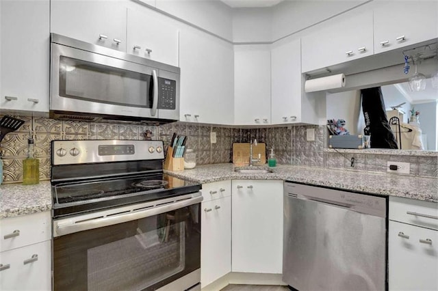 2870 Pharr Ct S Unit 503, Atlanta, GA 30305 - kitchen featuring stainless steel appliances, white cabinets, a sink, and backsplash
