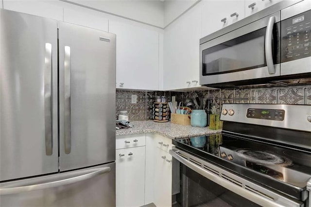 2870 Pharr Ct S Unit 503, Atlanta, GA 30305 - kitchen with stainless steel appliances, tasteful backsplash, white cabinets, and light stone counters