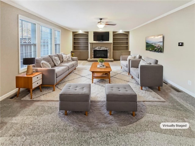 carpeted living room featuring ceiling fan, built in features, and ornamental molding