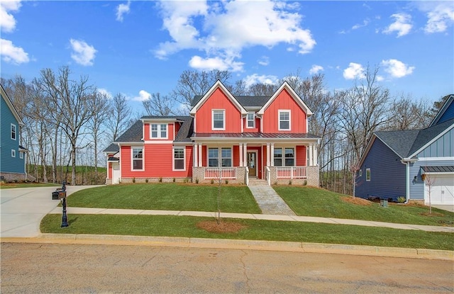 view of front of property with covered porch, a standing seam roof, board and batten siding, and a front yard