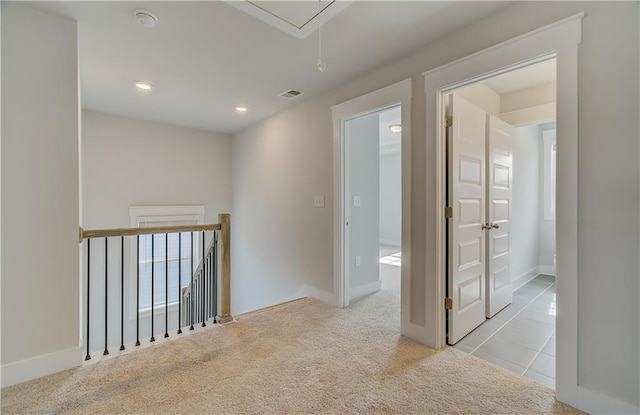 hall featuring recessed lighting, light colored carpet, visible vents, an upstairs landing, and attic access