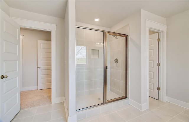 bathroom featuring recessed lighting, tile patterned flooring, baseboards, and a shower stall