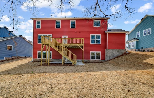 rear view of property with a deck and stairway