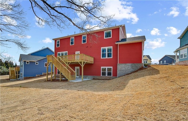 back of house featuring stairway and a deck