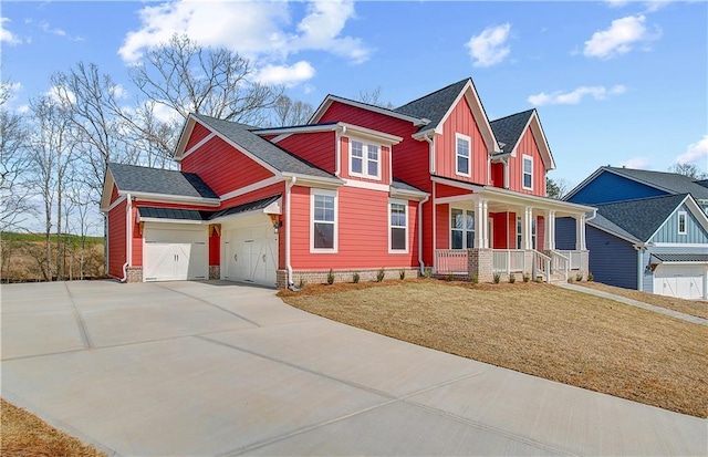 view of front facade featuring a porch, a garage, driveway, a front lawn, and board and batten siding