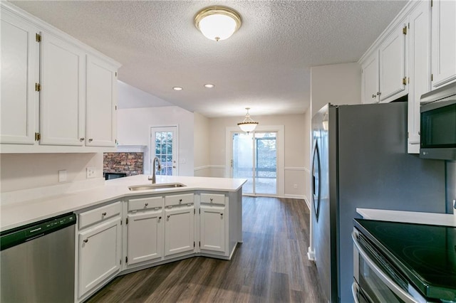 kitchen featuring kitchen peninsula, stainless steel appliances, white cabinetry, and sink