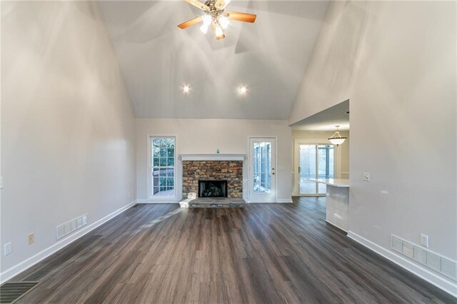 unfurnished living room featuring dark hardwood / wood-style floors, ceiling fan, a fireplace, and high vaulted ceiling