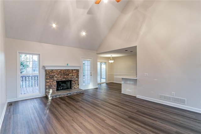 unfurnished living room with a fireplace, ceiling fan, dark hardwood / wood-style flooring, and high vaulted ceiling