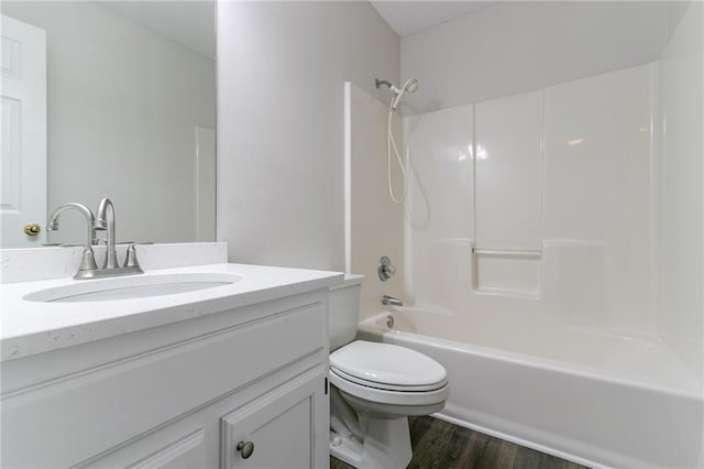 full bathroom with bathtub / shower combination, vanity, hardwood / wood-style flooring, and toilet