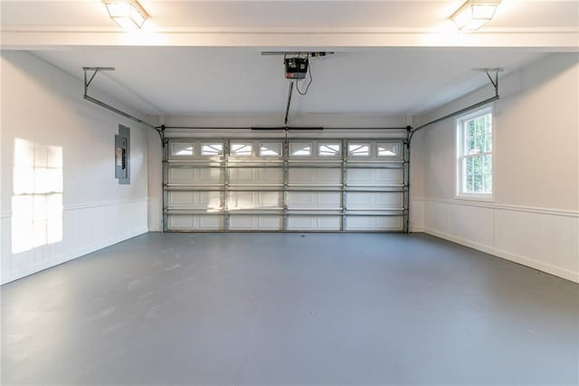 garage with electric panel and a garage door opener