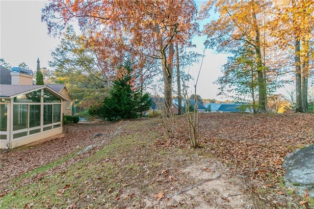 view of yard featuring a sunroom