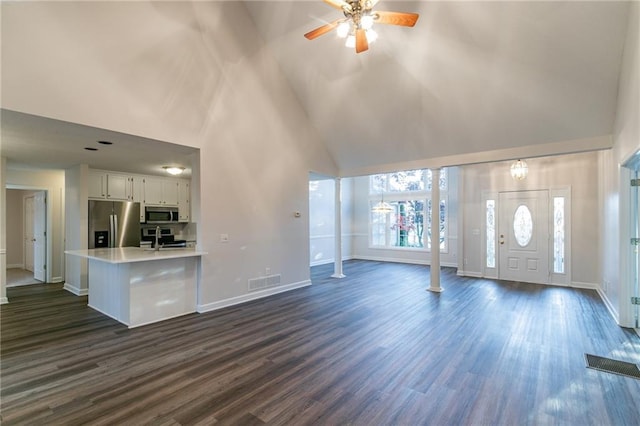 unfurnished living room with ceiling fan, sink, high vaulted ceiling, and dark hardwood / wood-style floors