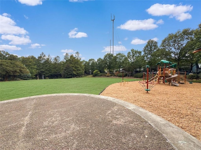 view of home's community with a playground and a yard