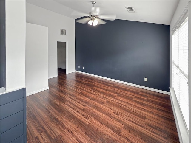 empty room featuring ceiling fan, dark wood-type flooring, and lofted ceiling