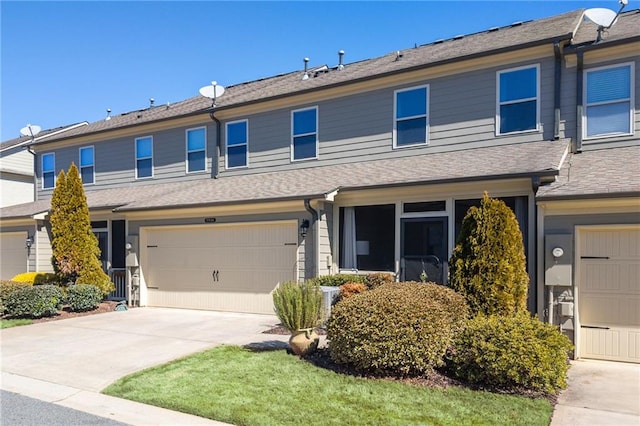 view of property with a garage and concrete driveway