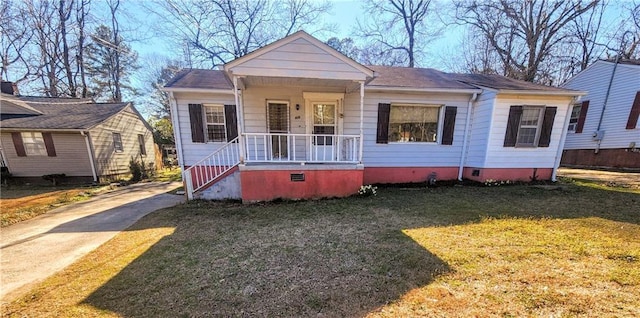 bungalow-style house with a front yard, covered porch, and crawl space