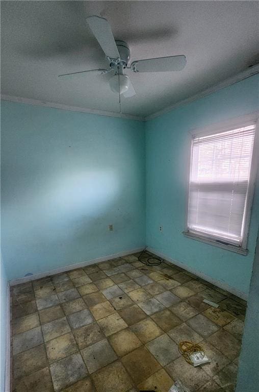 empty room featuring ceiling fan and ornamental molding