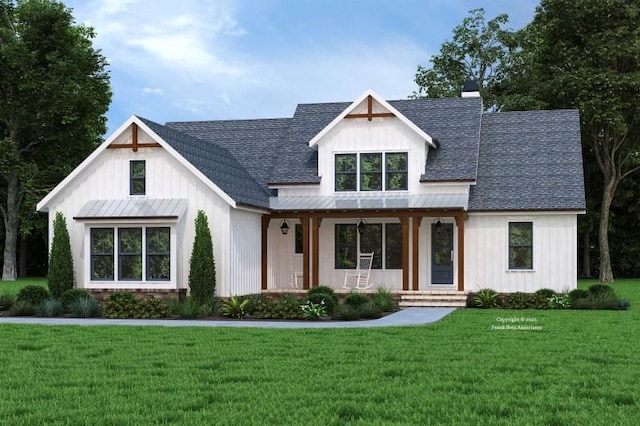 modern farmhouse style home with a front yard, metal roof, board and batten siding, and a shingled roof