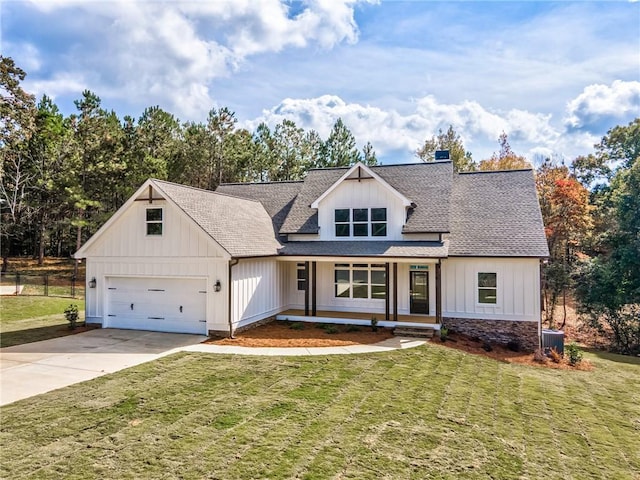 modern farmhouse style home with board and batten siding, a shingled roof, a front lawn, a garage, and driveway