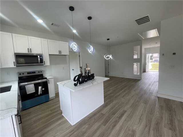 kitchen with visible vents, light wood-type flooring, white cabinetry, and stainless steel appliances