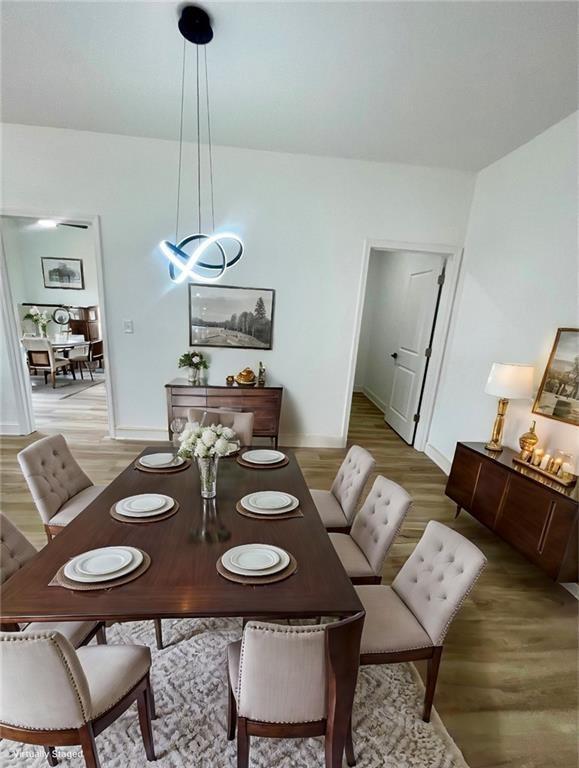 dining room featuring baseboards and light wood-style flooring
