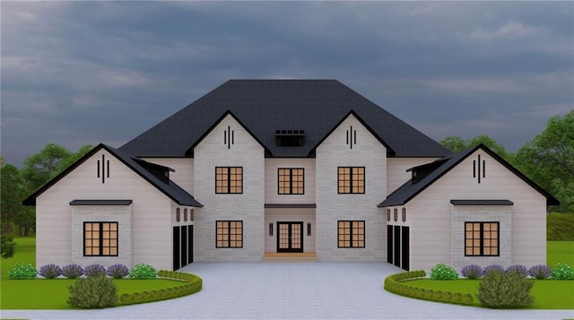 view of front of house with stone siding, driveway, and french doors