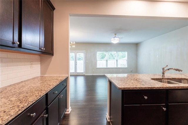 382 Mulberry Row SE, Atlanta, GA 30354 - kitchen featuring dark wood finished floors, light stone counters, backsplash, dark brown cabinetry, and open floor plan