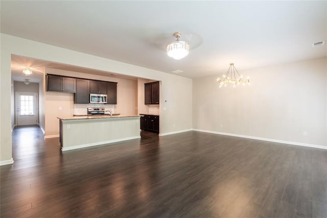 382 Mulberry Row SE, Atlanta, GA 30354 - unfurnished living room featuring a chandelier and dark wood finished floors