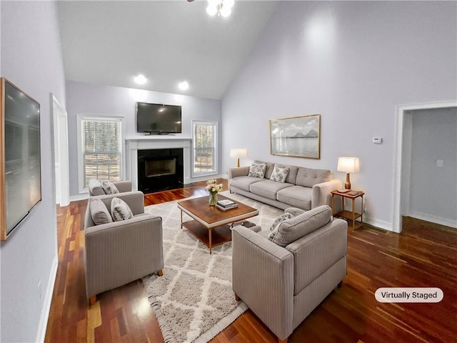 living room featuring hardwood / wood-style flooring and high vaulted ceiling