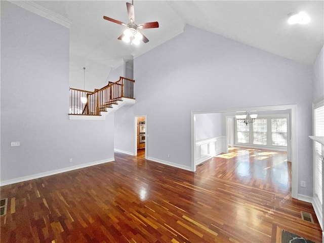 unfurnished living room with high vaulted ceiling, dark wood-type flooring, ceiling fan with notable chandelier, and ornamental molding