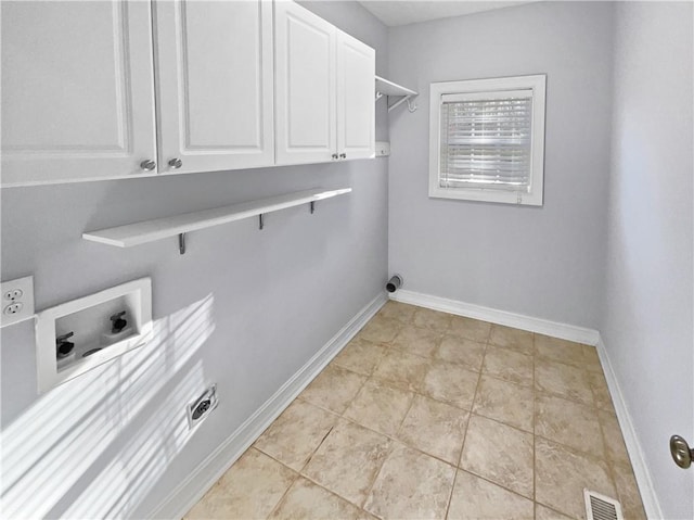 laundry room featuring hookup for a washing machine, light tile patterned flooring, and cabinets