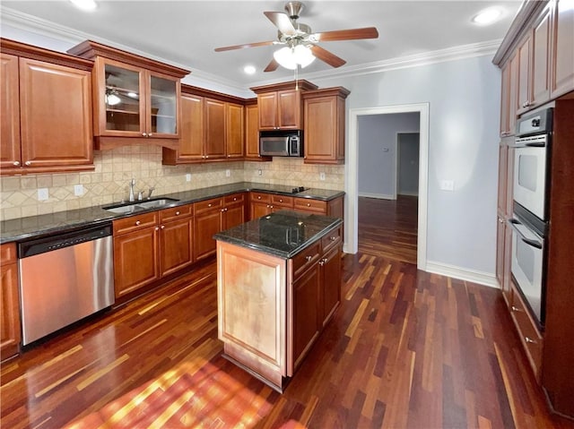 kitchen with a center island, ornamental molding, sink, and appliances with stainless steel finishes