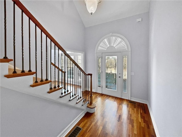 foyer with hardwood / wood-style floors and a high ceiling