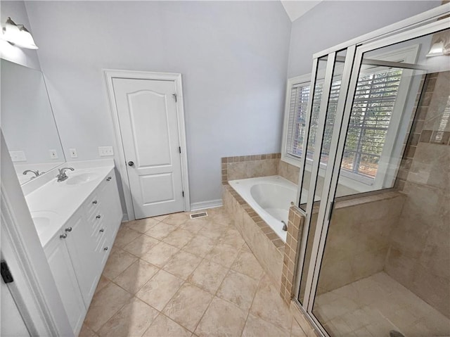 bathroom with tile patterned floors, vanity, plus walk in shower, and vaulted ceiling