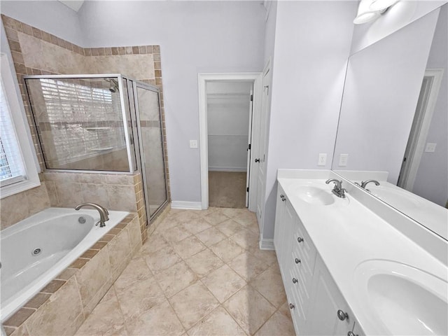 bathroom with vanity and independent shower and bath