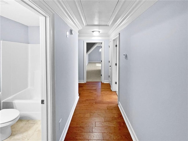 corridor with hardwood / wood-style floors and crown molding