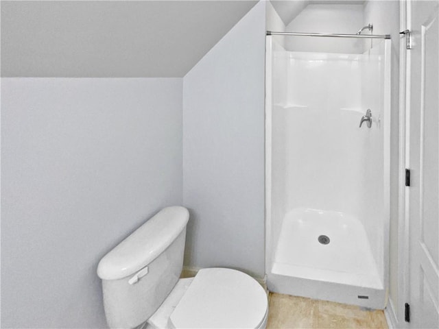 bathroom featuring toilet, walk in shower, and lofted ceiling