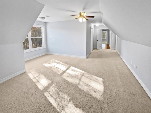 bonus room featuring ceiling fan, light carpet, and lofted ceiling