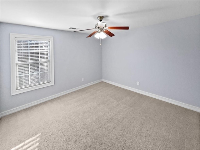 carpeted spare room with ceiling fan