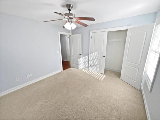 unfurnished bedroom featuring a closet, ceiling fan, and light colored carpet